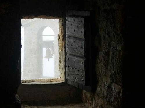 The arty shot of misty bell through window