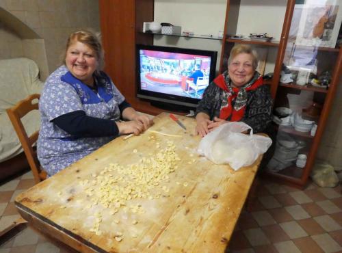 This lovely lady and her mother called us inside for a chat; she talked to us, greeted passing neighbours and kept an ear on the TV - all without  missing a beat in making her pasta