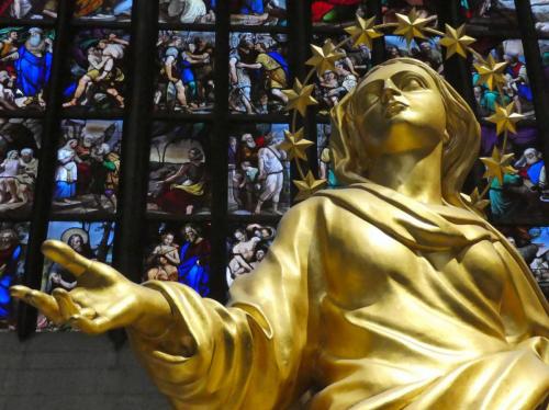 The golden statue of the Virgin Mary, La Madonnina, stands on the Cathedral's highest spire; an exact replica - created for Milan's Expo 2015 - is displayed inside the Duomo