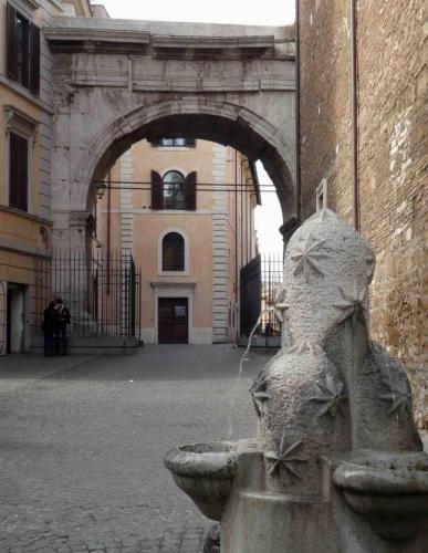 The Monti fountain (depicting the three hills) was commissioned in 1927, and behind it is Porta Esquilina, one of the original city gates (4 BC); Cicero spoke of entering Rome through this gate