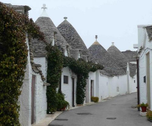 The sandstone pinnacle on top of each roof is the individual mark of the stonemason who built that trullo