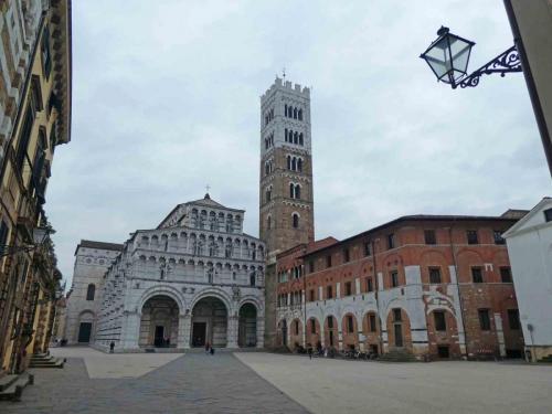 Lucca's Cathedral, San Martino, was built around the existing bell tower (which accounts for the smaller arch on the right)