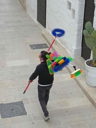 The local broom salesman announcing his arrival with a chant of 'le sco..le sco..le scope'; on this day business was brisk