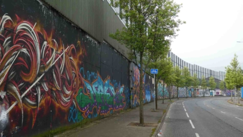 One of the famous 'peace walls', barriers built to separate Republican and Loyalist neighbourhoods; the gates in these walls are still closed at night