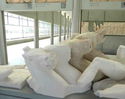 In the early 1800s Lord Elgin had about half of the Parthenon's remaining marble sculptures removed and carried off to England (where they're still on display in the British Museum); while the Acropolis Museum awaits their return, the missing sculptures are represented by white plaster replicas 