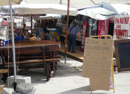 With much of the town still little more than rubble, locals have set up stalls in an open area at the top of the road