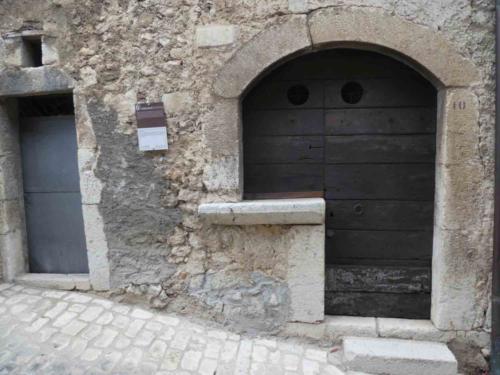 A medieval shop with the small opening above the counter 