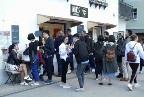 Every day buses deliver thousands of Chinese visitors into the tiny town