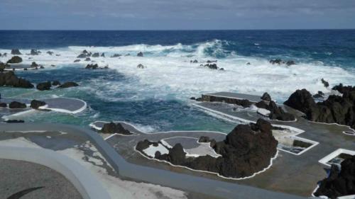 On days of less wind and lower tides, the black lava walls separate the pools from the ocean waves