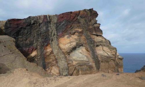 About half way along, there's a series of cliffs where the island's volcanic geology is on full display