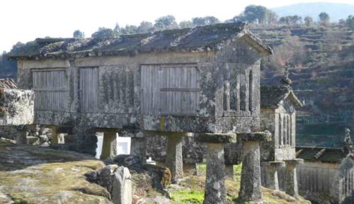 These stone structures were used for storing and drying grain; slats in the sides for airflow and 'caps' on the legs to deter rodents