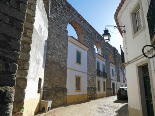 There's an aqueduct here too; the residents of Évora made good use of the space between the aqueduct's arches (though the washing still is done in the concrete tub on the street)