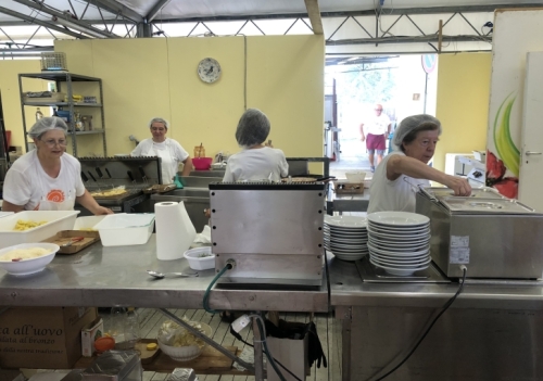 Again, an army of local volunteers comes together in a make-shift kitchen to produce hundreds of meals for hungry festival-goers.