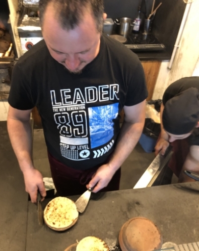 The panigacci cook between the plates. Then the stack is turned over, the clay plates are separated and the panigacci are ready to go. Loaded up with salumi and cheese, these are absolutely delicious.