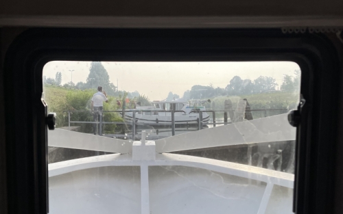 But it's not always plain sailing. This boat suffered a mechanical problem and blocked the canal for around half an hour - finally someone (our captain) had the good idea to enact an old-fashioned solution; attach a rope to the back of the boat and pull it along the tow-path until it straightens enough to reopen the canal.