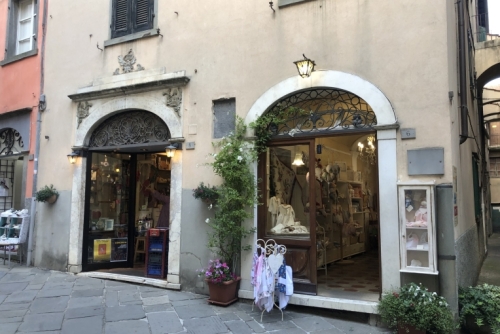 This shop on the left was once an apothecary. On the right, the original pharmacist's preparation area is now a shop selling baby clothes.