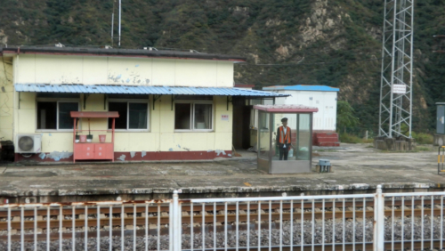 In China it seems that at every small station or siding, a railway employee stands to attention as trains pass (a lucky few have a small shelter to stand in - many don't)