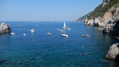 By late morning in summer, the little bay is filled with boats and swimmers
