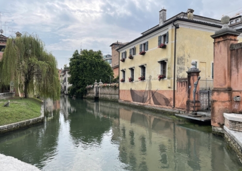 ... and little parks where willows weep towards the water. 